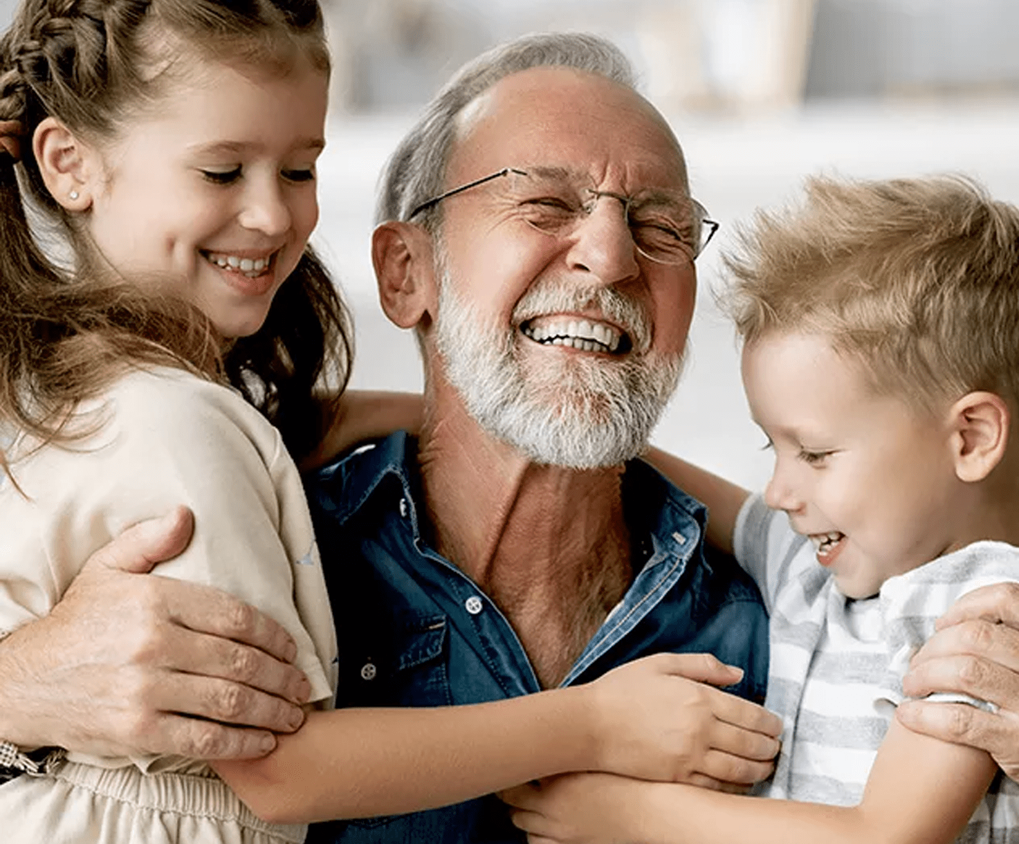 Picture of a happy man wearing Bernafon hearing aids, laughing with children